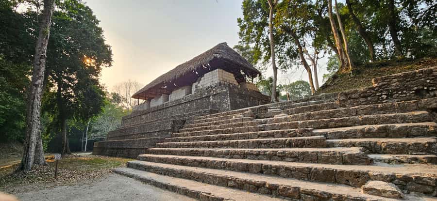From Flores: Yaxha at Sunset Guided Tour - Guided walking at Yaxha: squares, causeways, and ball courts